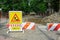 Inner city road closed by stone roadblocks during reconstruction. Yellow roadsign with the words in Ukrainian mean ROAD WORK,