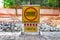 Inner city road with old pavement, closed by stone roadblocks during reconstruction. Yellow roadsign with the words in Ukrainian