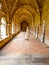 Inner cloister of an abbey with a monk walking and praying