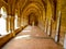 Inner cloister of an abbey with a monk walking and praying