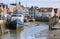 Inner harbor at low tide in the old town of Husum with boats on