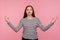 Inner peace, yoga meditation. Portrait of tranquil woman in striped sweatshirt holding hands in mudra gesture