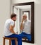 Inner talk. Man in his 30s looking in mirror with elderly reflection of him. Senior and young man. Conceptual collage