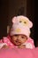 Innocent asian baby girl in pink winter cap