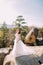 Innocent beautiful bride in luxurious wedding dress. Smiling girl at summer mountain landscape