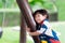 Innocent boy hugged the pole and made a cute face. Ragged child`s face. Children 2-3 years old. Happy baby wear colorful clothes.