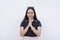 A innocent and optimistic young woman making a wish or praying. Isolated on a white backdrop