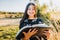 Innocent young religious girl with braces studying the bible, outside in the field at sunset. Spiritual revival