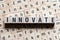 Innovate word written on wood block