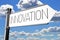 Innovation - signpost with white arrow, sky