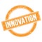 INNOVATION text on orange grungy round stamp