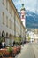 Innsbruck, Austria - April 17th 2021: Lively street with a restaurant in the historic city centre.