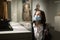 Inquisitive preteen girl in protective mask visiting historical museum