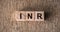 INR - International Normalized Ratio acronym on cubes on wooden surface. Medical concept