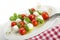 Insalata caprese sticks on plate, tilted view