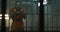 Insane female prisoner yells, jumps on bars in prison cell