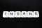 Insane text word title caption label cover backdrop background. Alphabet letter toy blocks on black reflective