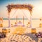In an insanely detailed modern destination wedding setup on a shimmering beach, the absence of people allows the warm color