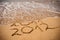 Inscription 2011 and 2012 on a beach sand