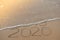 Inscription 2019 and 2020 on beach sand, wave covering 2019 digits. New Year 2020 coming concept