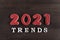 Inscription 2021 trends on wooden background. Popular destinations in 2021