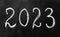 The inscription 2023 in chalk on a blackboard.