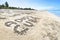 Inscription Adios Cuba on the sandy beach and sea water. translated from Spanish goodbye Cuba.