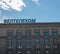 The inscription Beltelecom in Russian on the building against the blue sky.