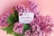 inscription best grandma ever on a white gift card in a beautiful spring bouquet of lilac