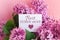inscription best sister ever on a white gift card in a beautiful spring bouquet of lilac