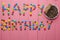 Inscription from candies on a pink background