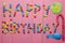 Inscription from candies on a pink background