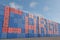 The inscription Cargo from red and blue cargo containers stacked in a terminal port