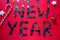 Inscription colored stars new year on a red background