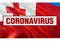 Inscription Coronavirus COVID-19 on Tonga flag background. World Health Organization WHO introduced new official name for