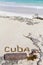 Inscription cube on the dense sand of the beach.