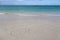 Inscription cube on the dense sand of the beach.