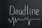 The inscription on a dark blackboard deadline with a curve line