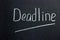 Inscription on a dark blackboard deadline with an underlined line