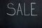 The inscription on the dark chalk board SALE