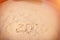 Inscription with a finger on the sand. Figures happy new year 2020. Fisheye lens