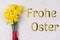 inscription Frohe Ostern with fresh flowers