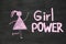 Inscription Girl Power and woman drawing symbol on chalkboard or