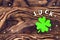 The inscription good luck and a leaf of clover on a dark wooden background. Valentine`s day celebration concept Patrick. Blank fo