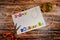 Inscription `Happy Halloween` with empty copy space on wooden table with pumpkin, scissors and lashing.