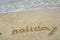 Inscription Holiday on the sand at the beach.