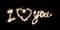 The inscription I love you on a black with sparklers using a simulated long exposure