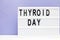 Inscription international thyroid day on purple background. copy space
