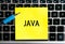 The inscription `JAVA` on a yellow sheet of sticker paper