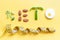 Inscription keto composed of vegetables and measuring tape on yellow background